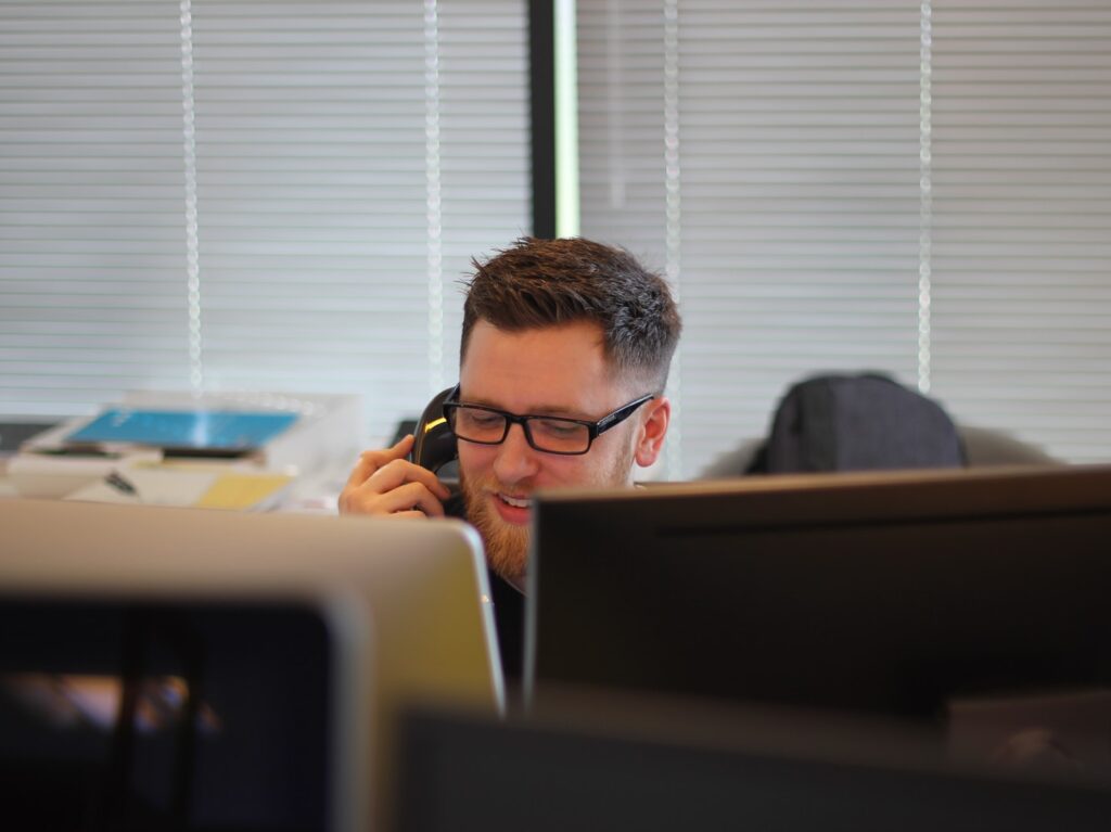 man using IP phone inside room