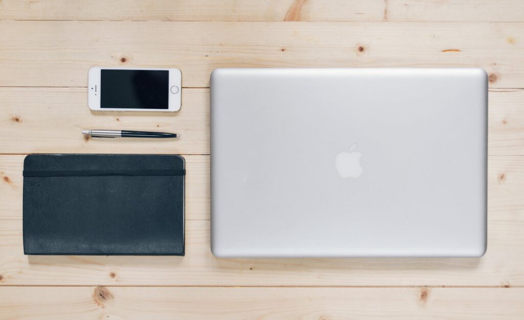 Silver Macbook Beside Wallet