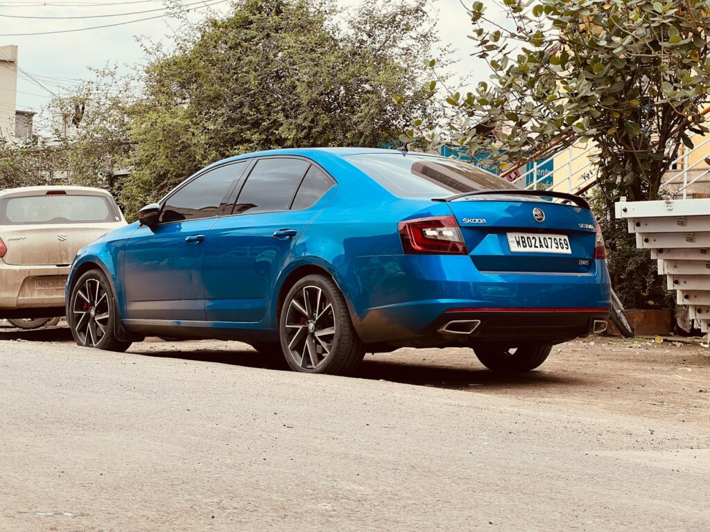 a blue car parked on the side of the road