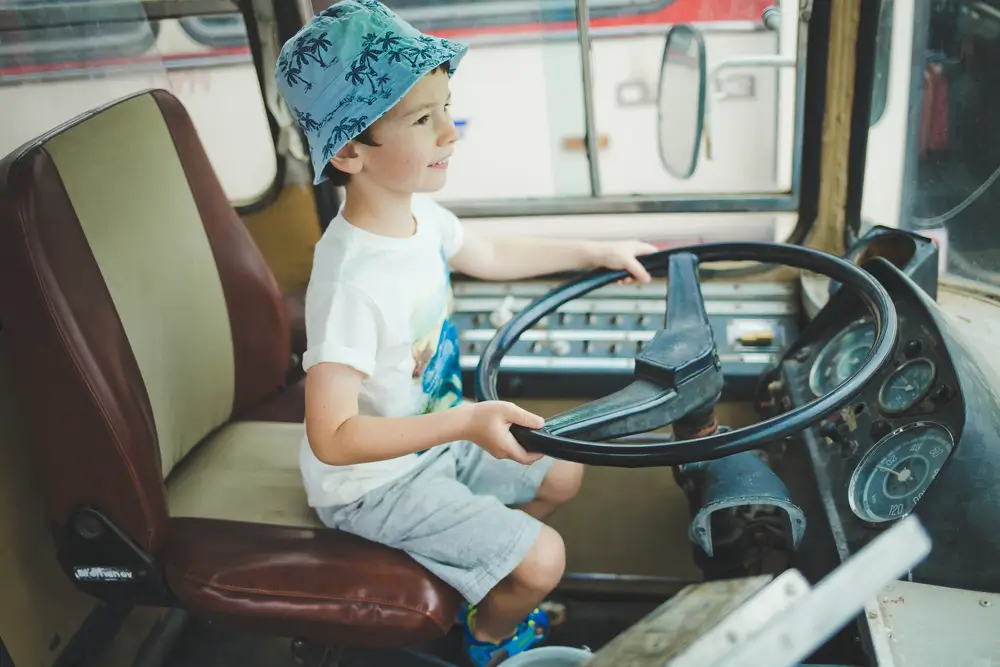 chlapec na místě řidiče autobusu