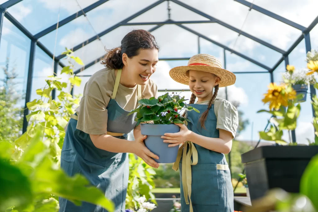Žena, která zahradničí se svou malou dcerou.