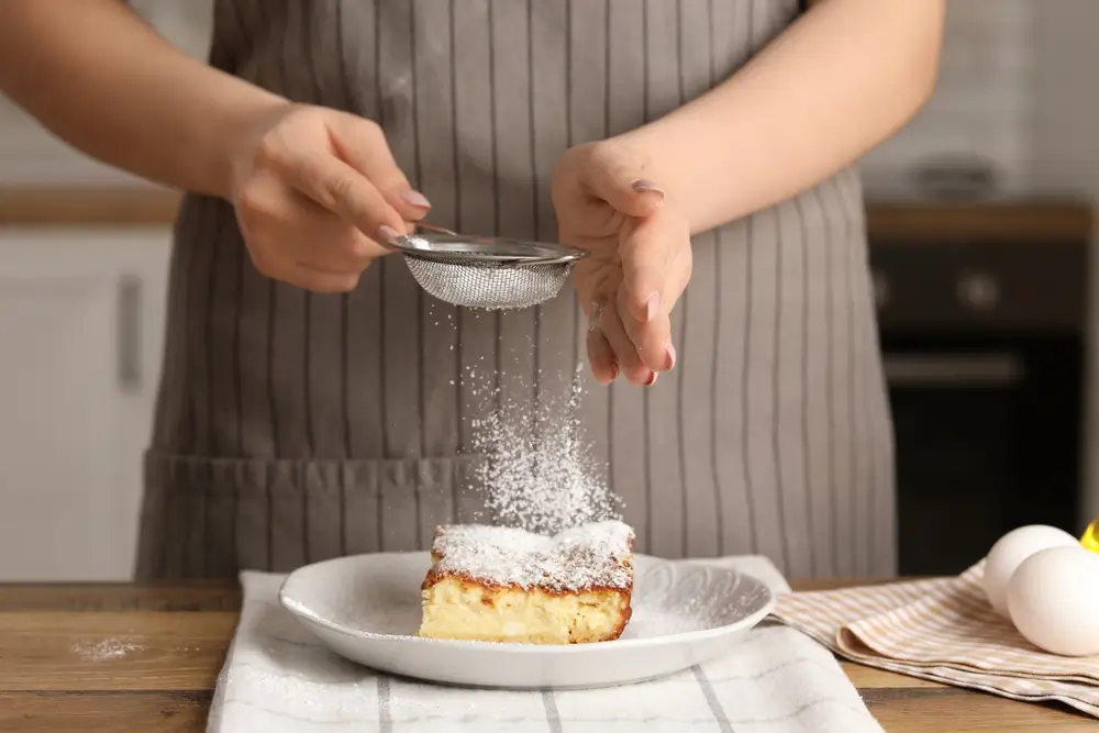 Žena cukruje buchtu. 