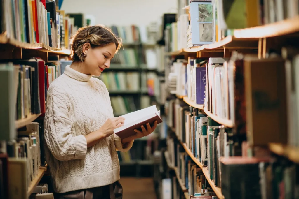 Žena čte knihu v knihovně