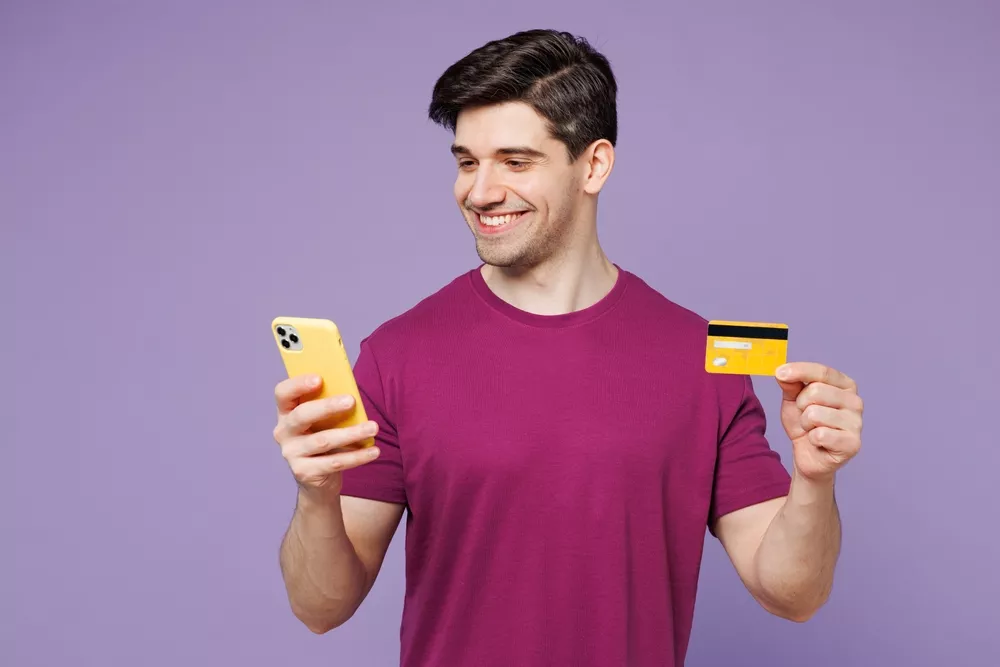šťastný muž u placení kartou