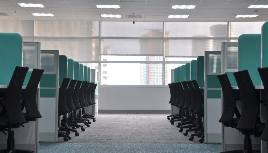 empty black rolling chairs at cubicles