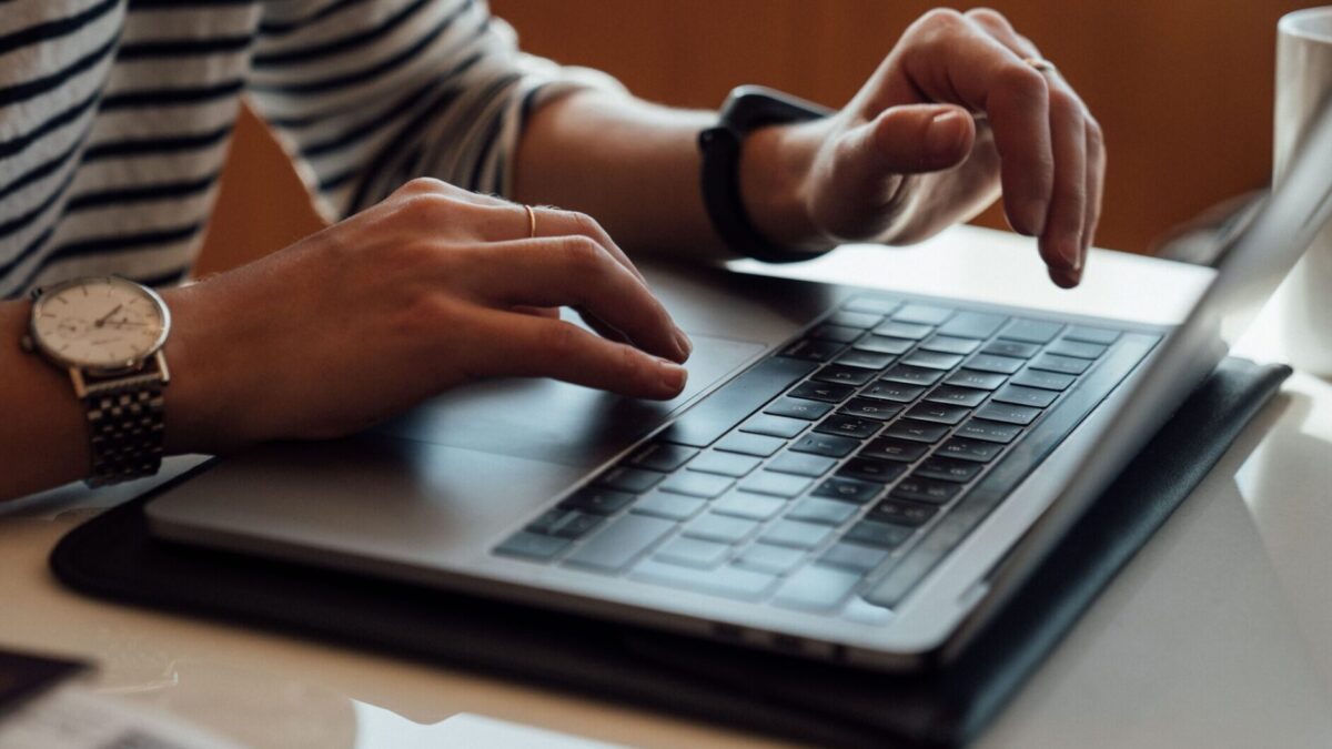 person seated at the table using laptop