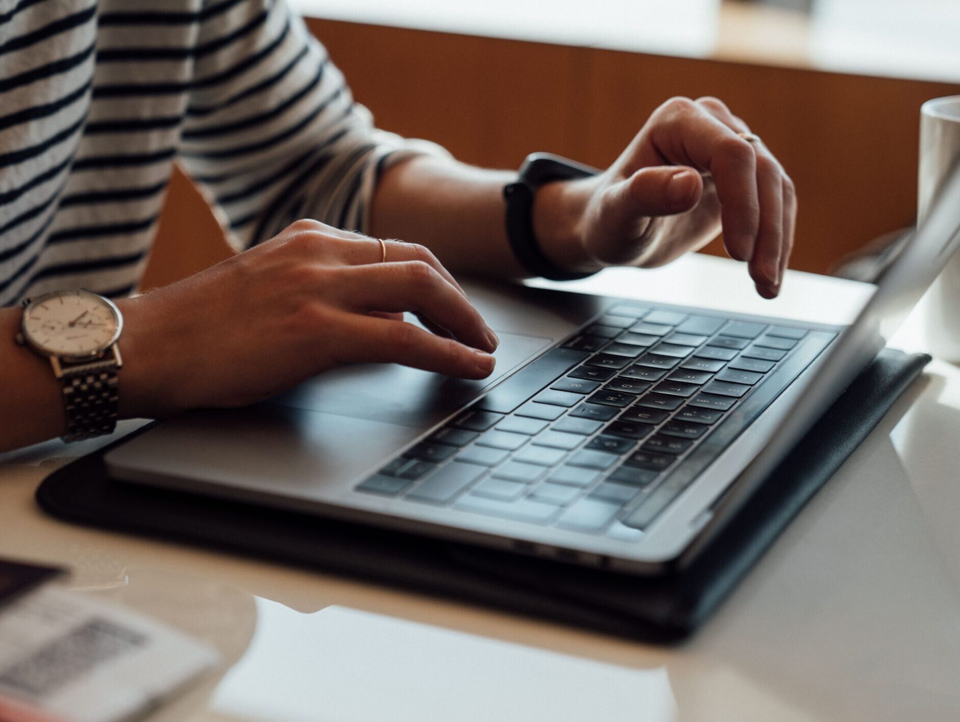 person seated at the table using laptop