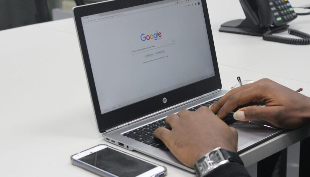 person typing on gray and black HP laptop