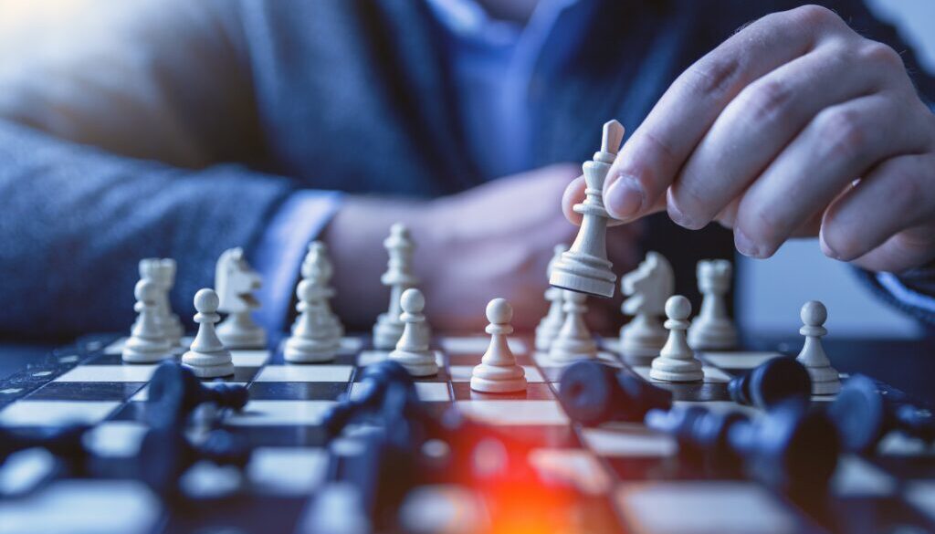 depth of field photography of man playing chess