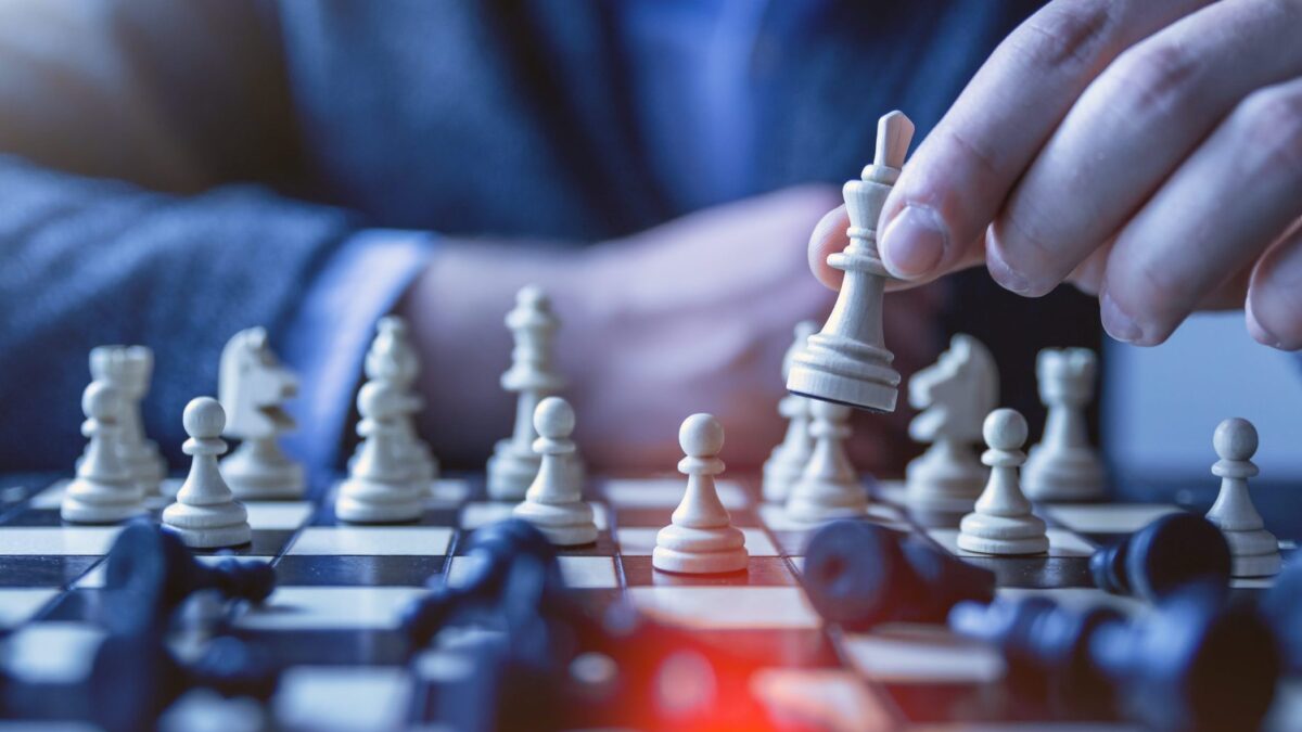 depth of field photography of man playing chess
