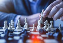 depth of field photography of man playing chess