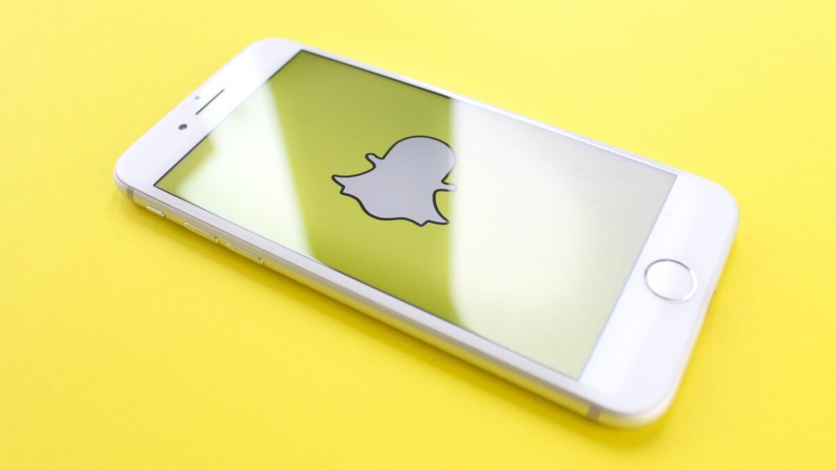 silver iPhone 6 on top of yellow wooden surface