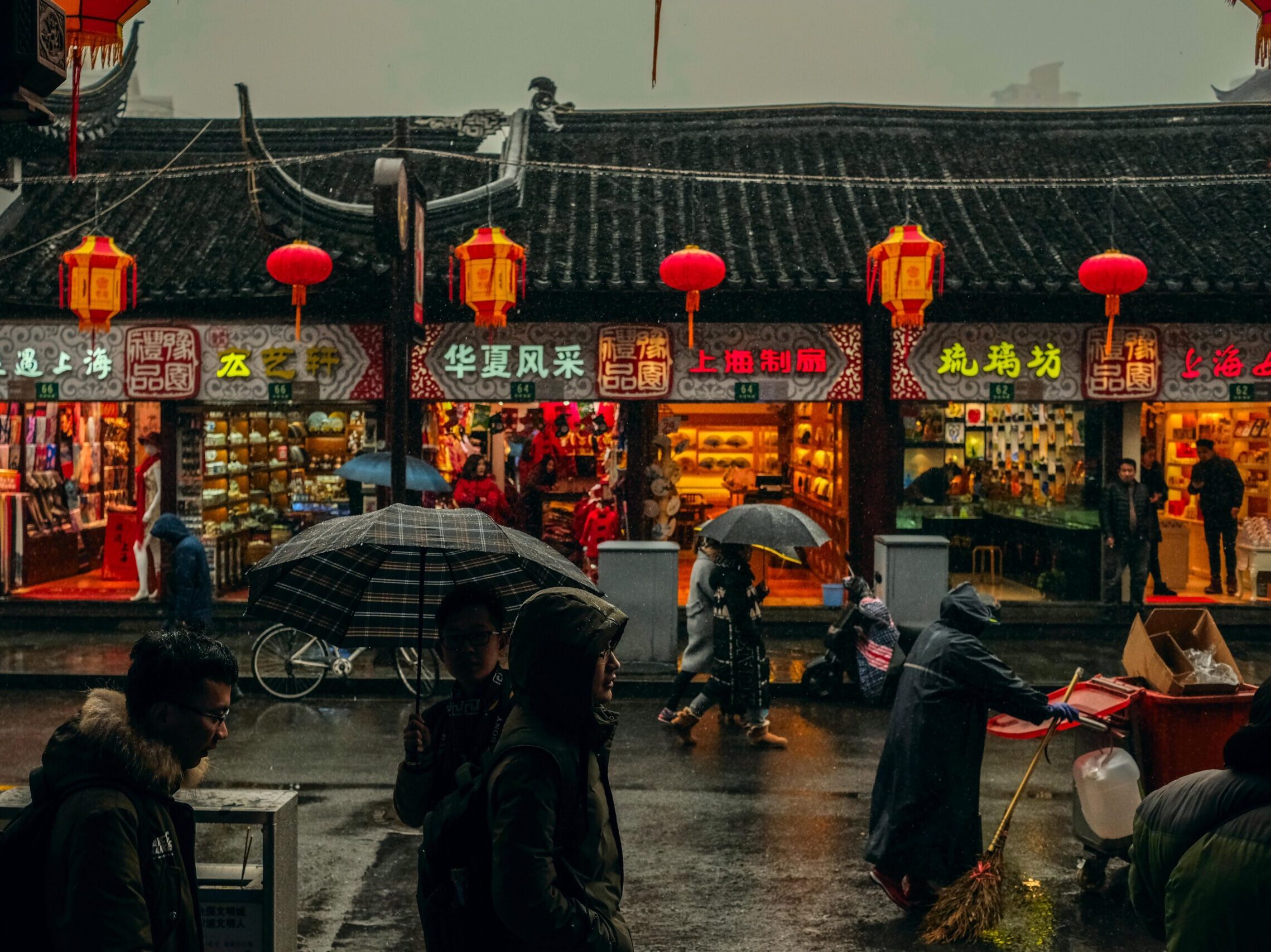 person carrying umbrellas