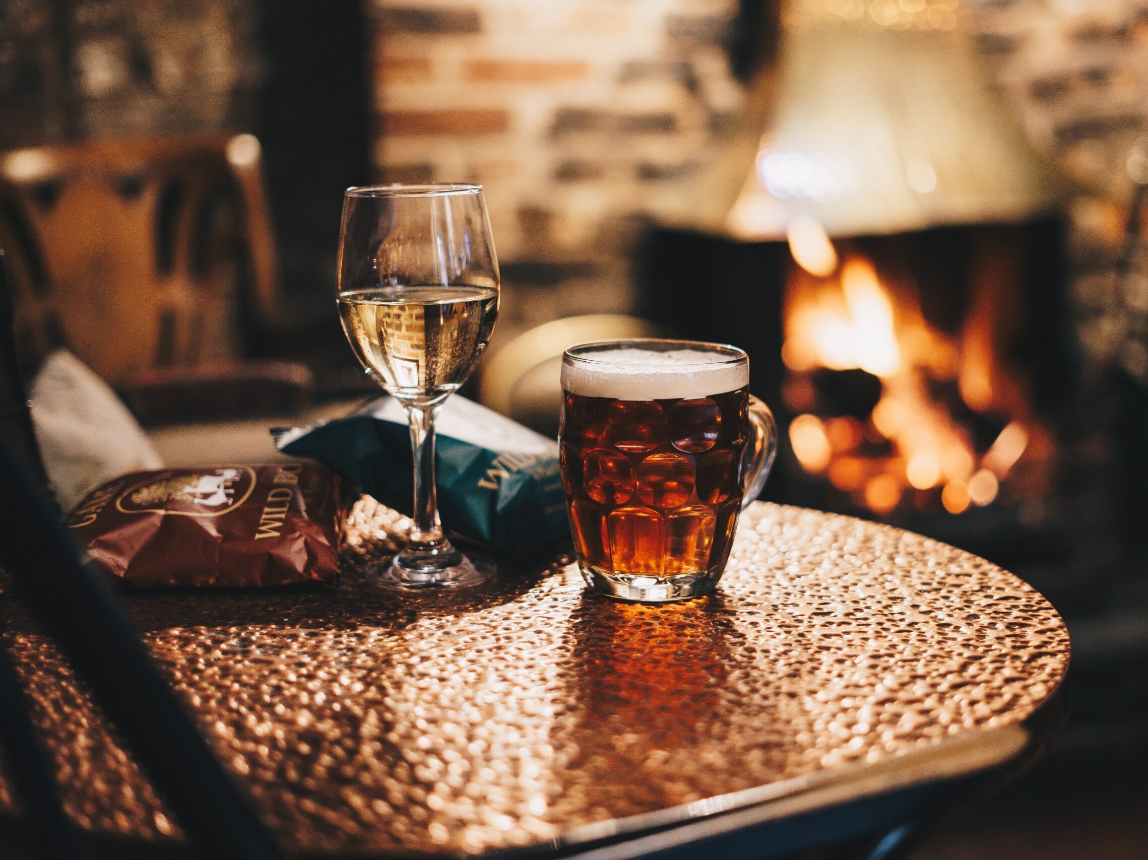 clear drinking glass with brown liquid on brown wooden table