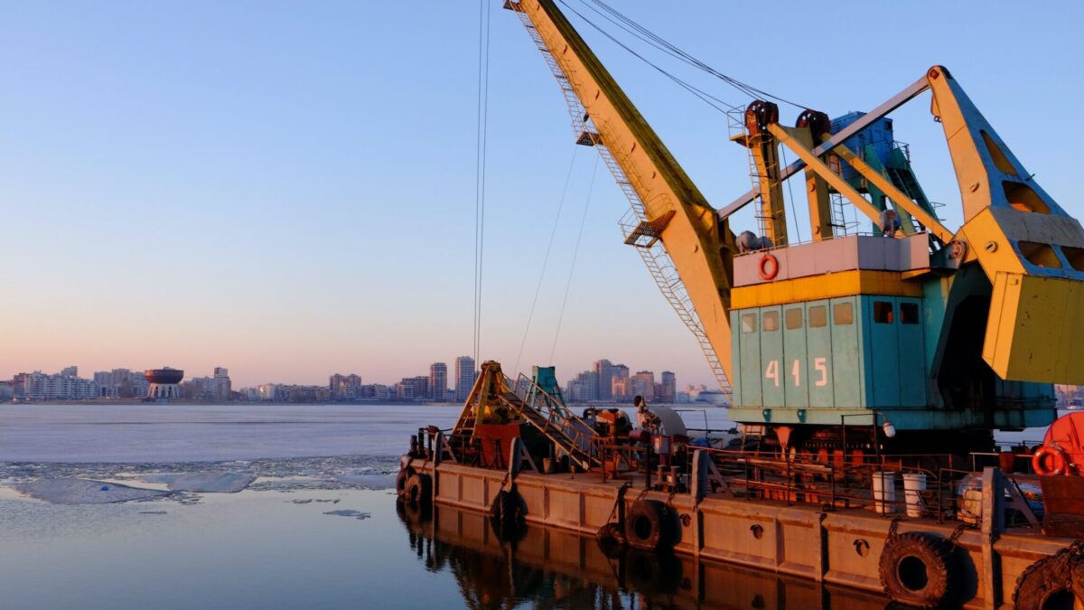 yellow and blue commercial machine near body of water