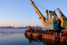yellow and blue commercial machine near body of water