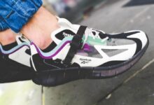 person wearing black white and green nike athletic shoe
