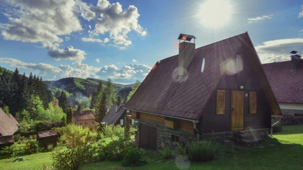 brown and gray house near green trees under blue sky during daytime