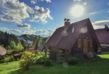 brown and gray house near green trees under blue sky during daytime
