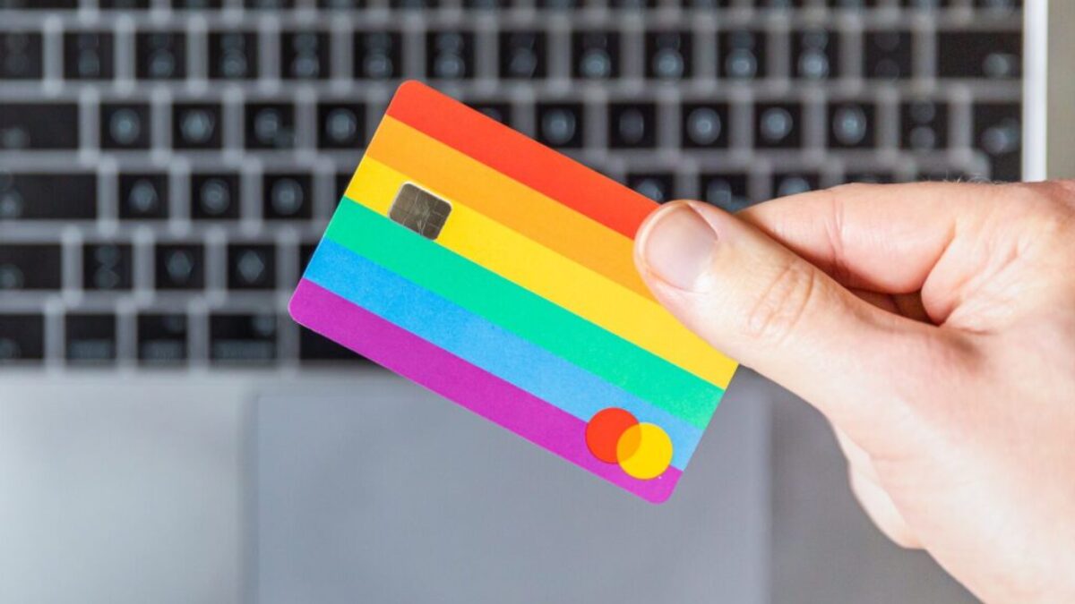 person holding yellow and pink card