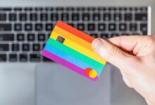 person holding yellow and pink card