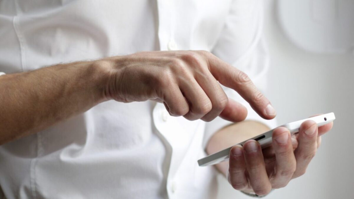 person holding white Android smartphone in white shirt