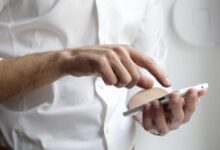 person holding white Android smartphone in white shirt