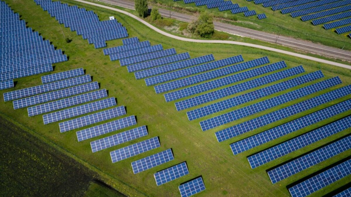 aerial photography of grass field with blue solar panels