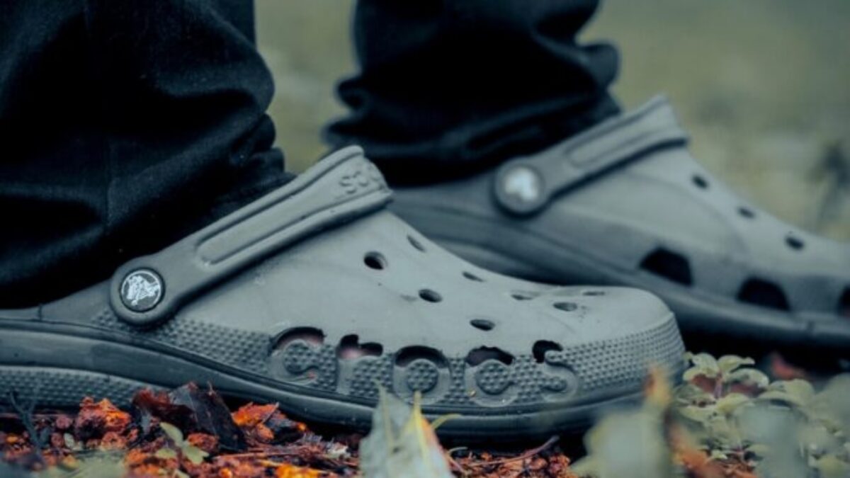 person wearing black converse all star high top sneakers
