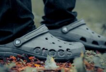 person wearing black converse all star high top sneakers