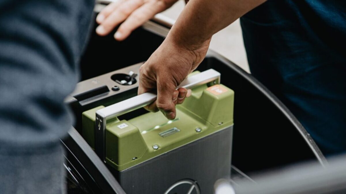 person holding black and green electronic device