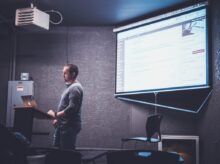 person standing in front of brown lectern