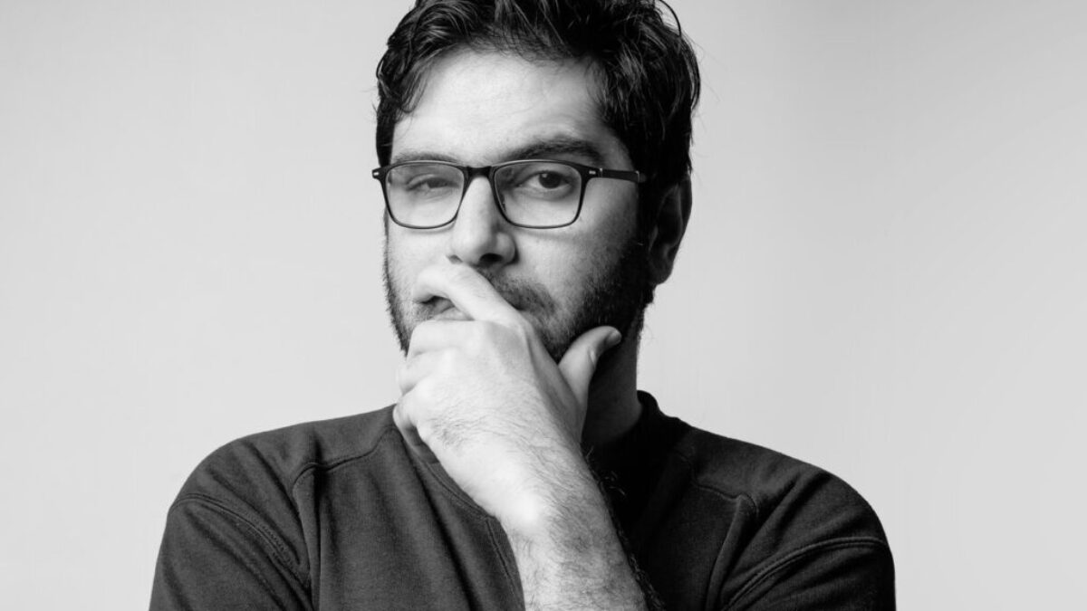 man in black long sleeve shirt wearing black framed eyeglasses
