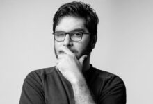 man in black long sleeve shirt wearing black framed eyeglasses