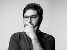 man in black long sleeve shirt wearing black framed eyeglasses