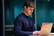 man in black long sleeve shirt using macbook