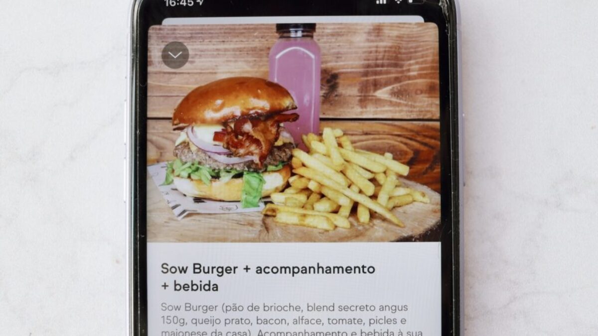 burger and fries on black and white tray