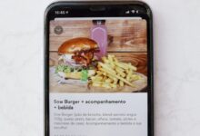 burger and fries on black and white tray