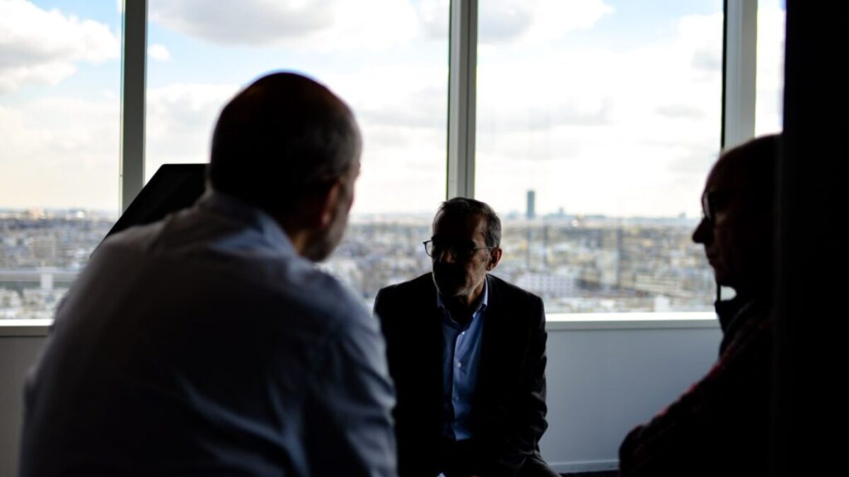 people sitting near window having conversations
