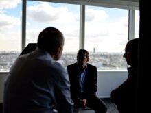 people sitting near window having conversations