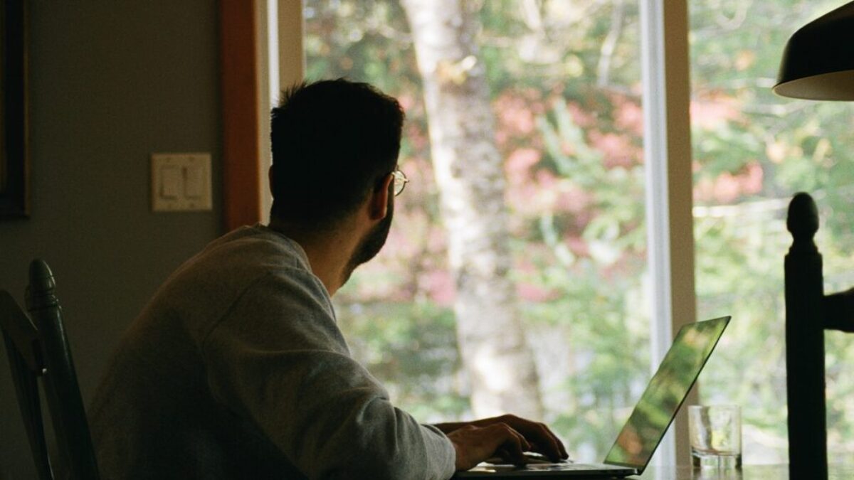man in gray hoodie using laptop computer