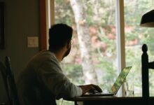 man in gray hoodie using laptop computer