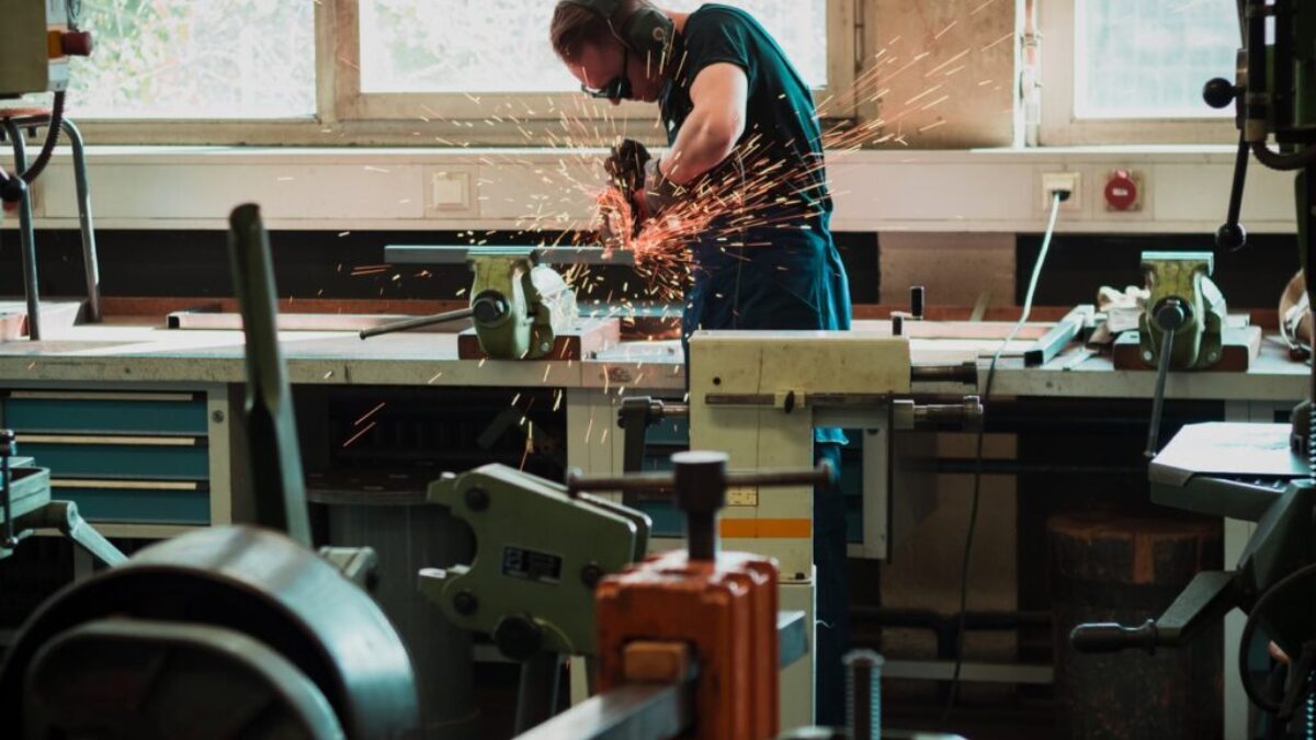 selective focus photography of man using angle grinder