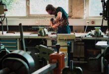 selective focus photography of man using angle grinder