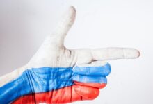 persons hand with blue paint