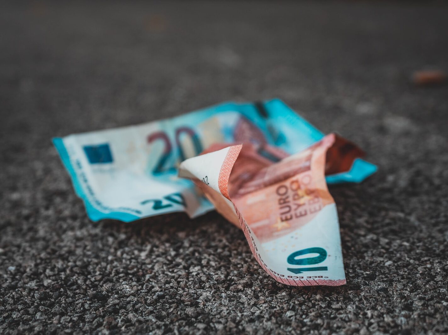 10 and 20 banknotes on concrete surface
