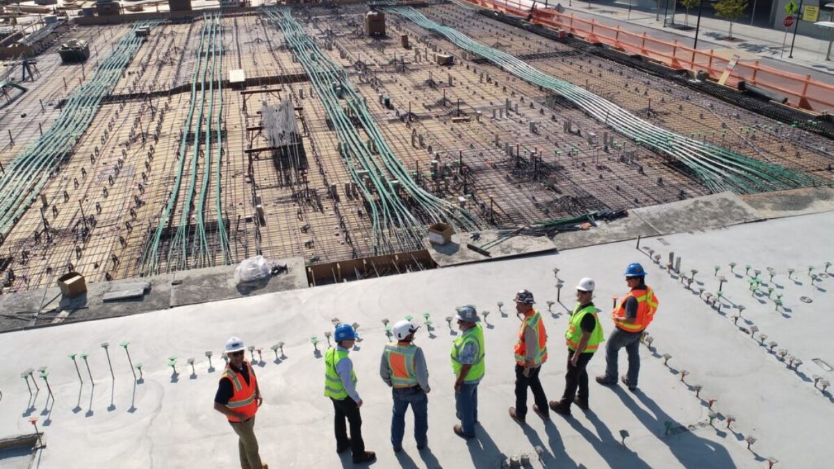 seven construction workers standing on white field