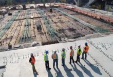seven construction workers standing on white field