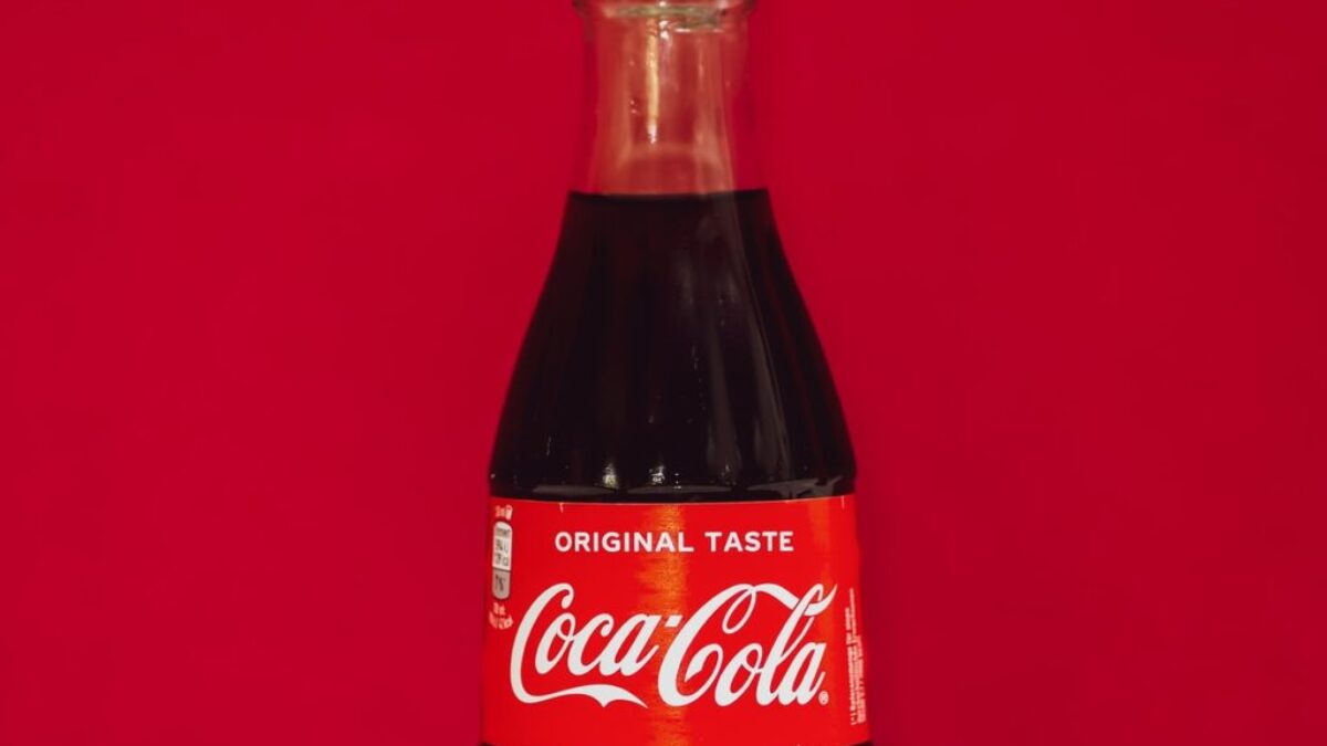 coca cola bottle on red surface