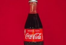 coca cola bottle on red surface